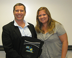 Sarah Houge, a second year student in the international development master&rsquo;s program, presents a gift of thanks to David Morrissey, executive director of the United States International Council on Disability (USICD).